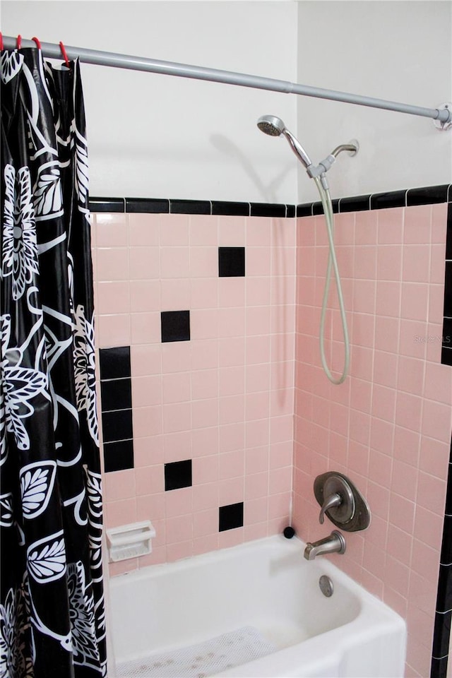 bathroom with shower / bathtub combination with curtain