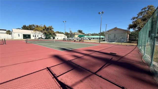 view of tennis court with basketball hoop