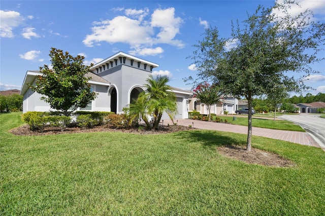 view of front of house with a garage and a front lawn