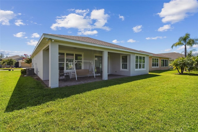 back of property featuring a patio, central air condition unit, and a yard