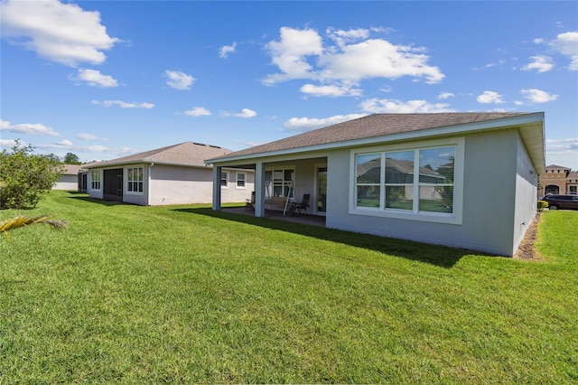 back of property featuring a lawn and a patio area