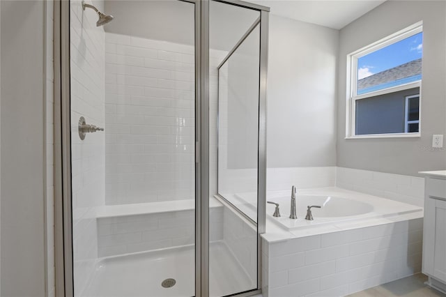 bathroom with independent shower and bath and vanity