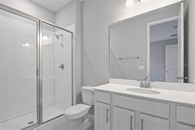 bathroom featuring walk in shower, vanity, and toilet