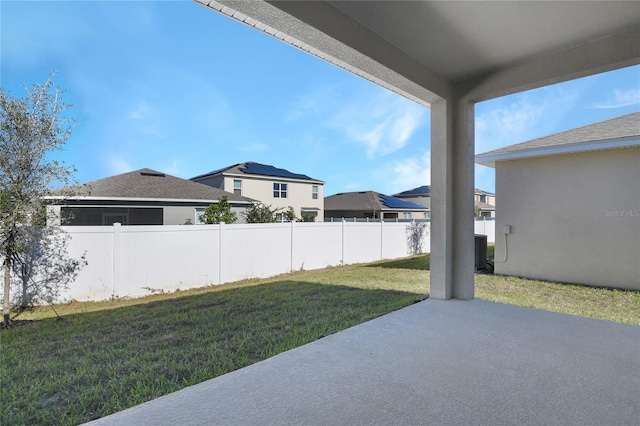 view of yard with central AC and a patio area