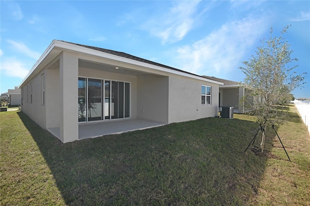 back of house featuring a patio, a lawn, and central air condition unit