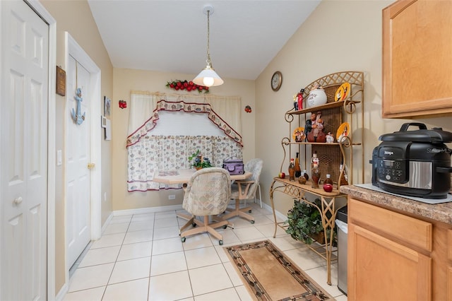 tiled dining space featuring lofted ceiling