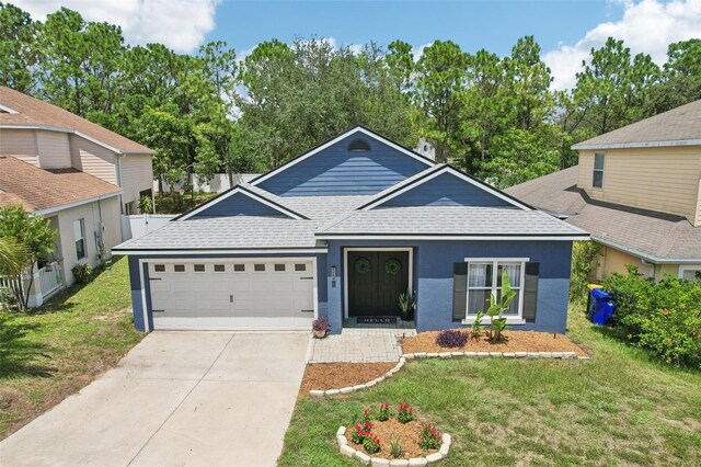 view of front of house featuring a front lawn and a garage