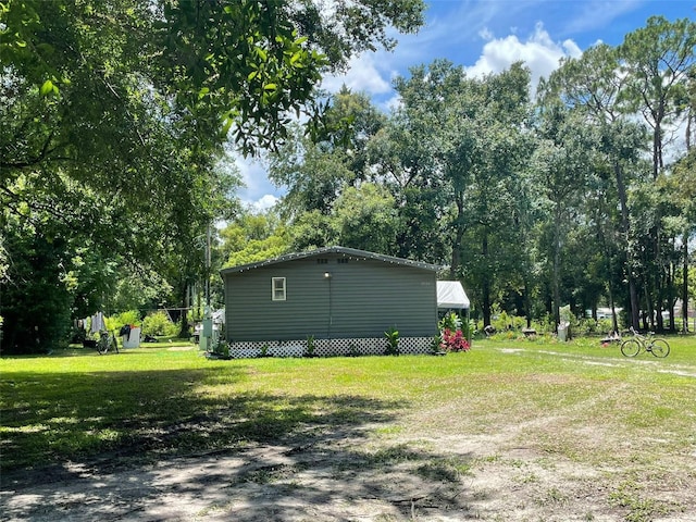 view of side of property with a lawn