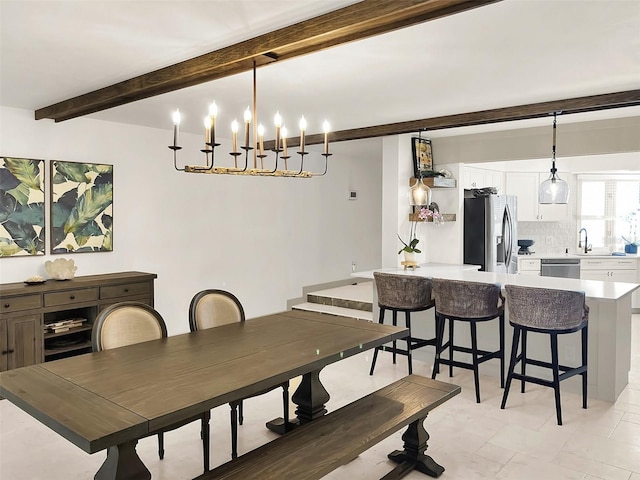 dining area featuring beam ceiling