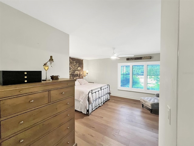 bedroom with light wood-type flooring and ceiling fan