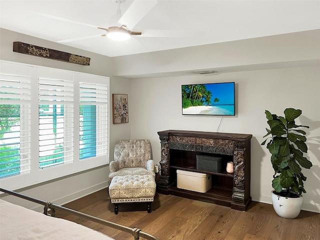 bedroom with ceiling fan, baseboards, and wood finished floors