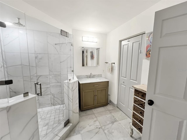 full bathroom featuring marble finish floor, a marble finish shower, and vanity