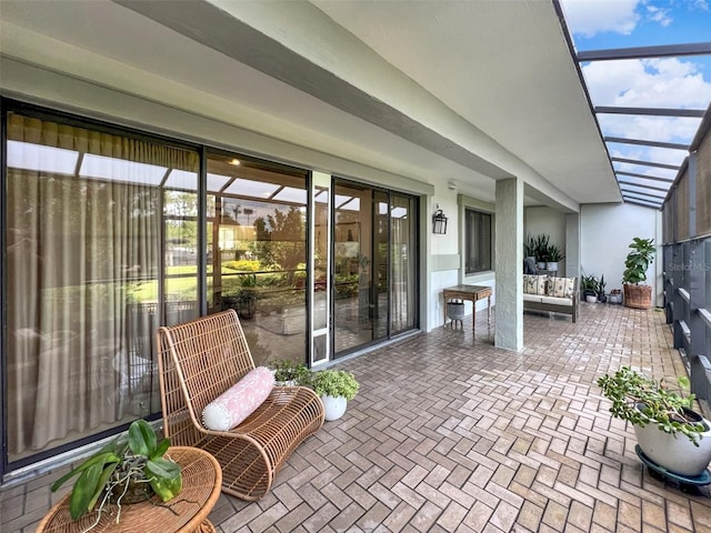 view of patio / terrace featuring glass enclosure