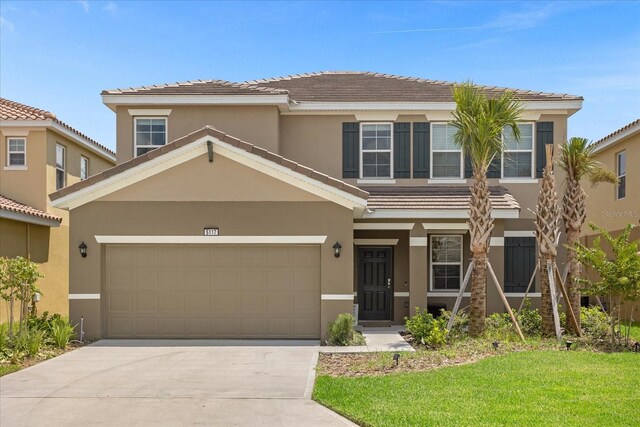 view of front of home featuring a garage and a front lawn