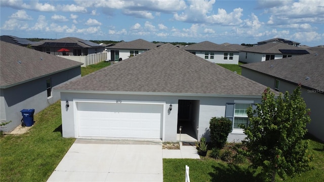 view of front of home featuring solar panels, a garage, and a front yard