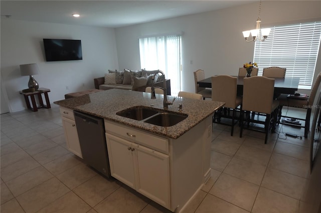 kitchen with dishwashing machine, white cabinets, sink, and light stone countertops