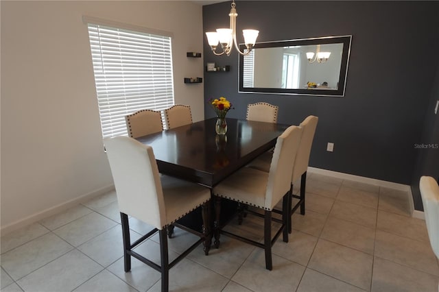 tiled dining space featuring a wealth of natural light and a notable chandelier