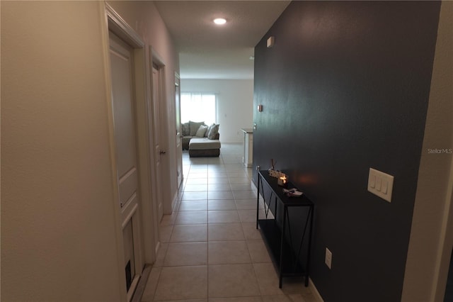 corridor featuring light tile patterned floors