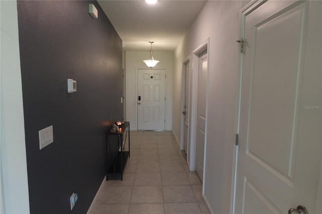 hallway featuring light tile patterned floors