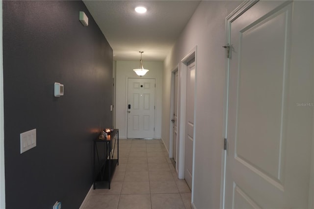 hallway featuring light tile patterned floors