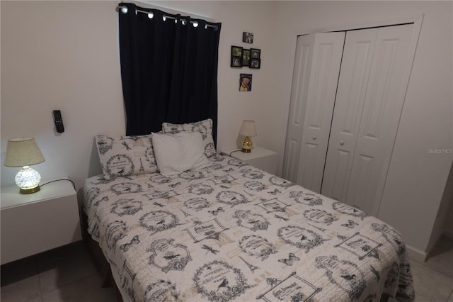 tiled bedroom with a closet