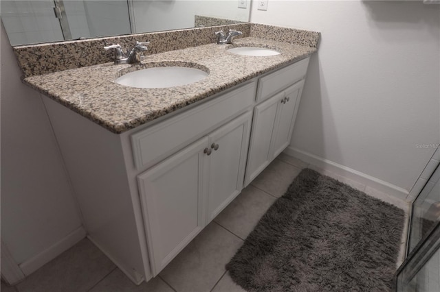 bathroom featuring tile patterned flooring and dual vanity