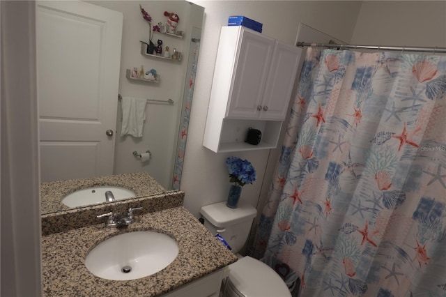 bathroom featuring vanity and toilet