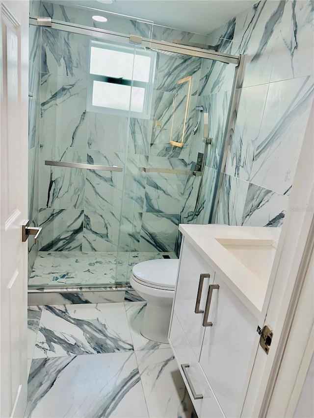 bathroom featuring vanity, toilet, and a shower with shower door