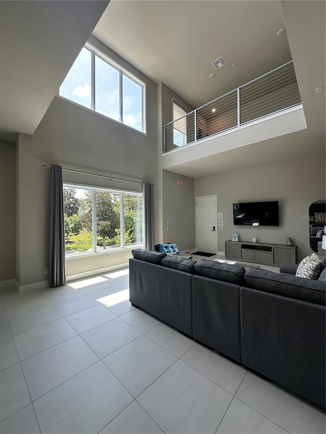 tiled living room featuring a towering ceiling