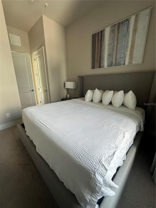 bedroom featuring carpet and baseboards