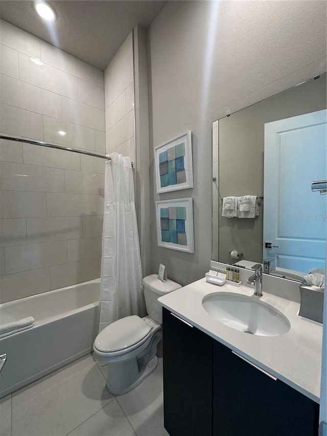 bathroom with shower / tub combo, toilet, vanity, and tile patterned flooring