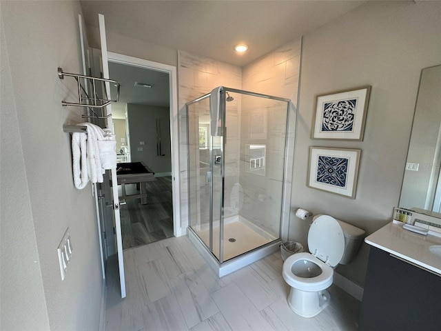 bathroom featuring tile patterned floors, vanity, an enclosed shower, and toilet