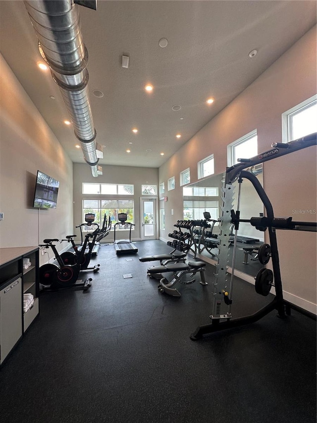 workout area with recessed lighting and baseboards