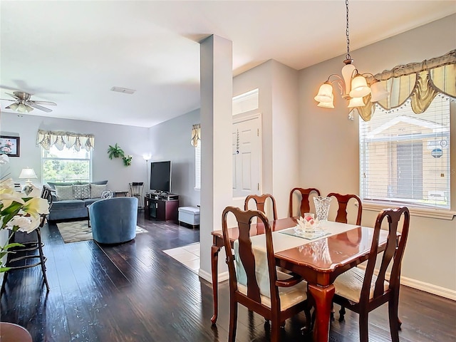 dining area featuring visible vents, baseboards, dark wood finished floors, and ceiling fan with notable chandelier