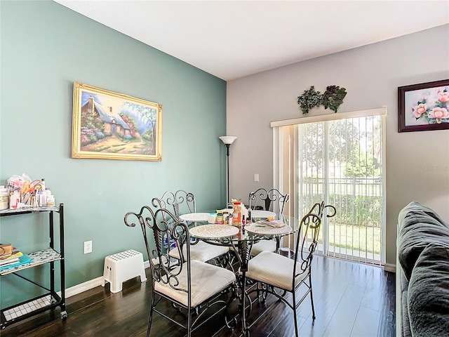 dining area with dark wood-style flooring, plenty of natural light, and baseboards