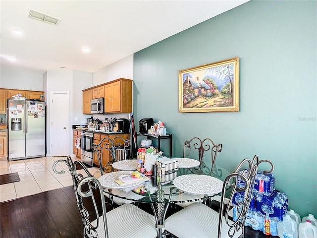 dining room with light tile patterned flooring, visible vents, and recessed lighting