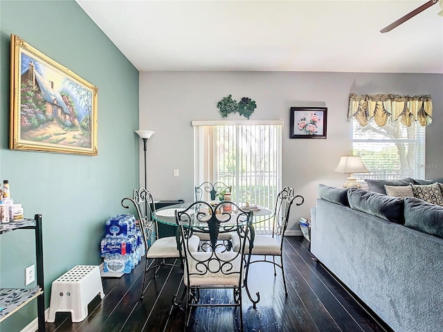 dining space with a ceiling fan, dark wood-style flooring, and baseboards