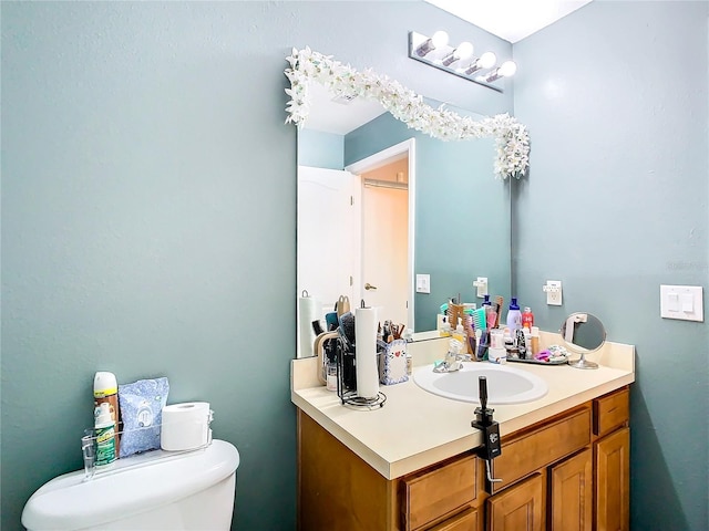 bathroom featuring toilet and vanity