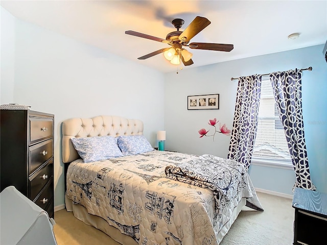 bedroom with ceiling fan, baseboards, and light colored carpet