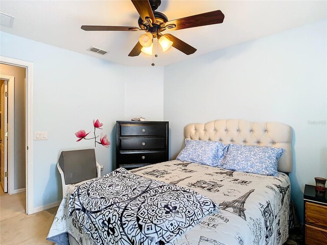 bedroom with a ceiling fan, visible vents, light carpet, and baseboards