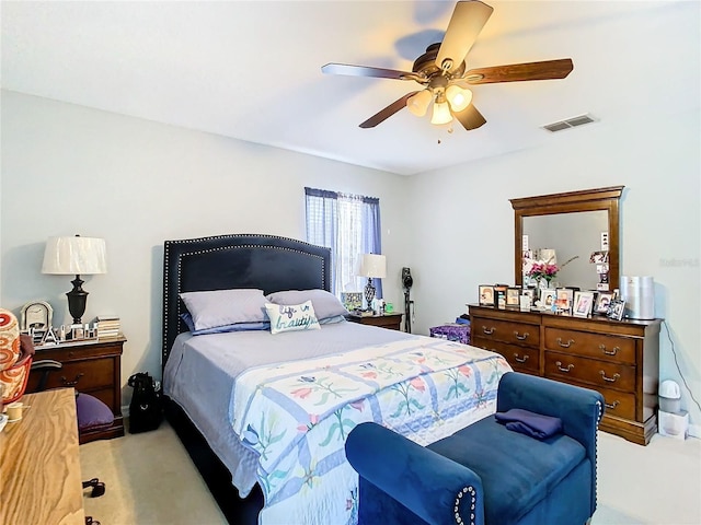 bedroom featuring light carpet, visible vents, and a ceiling fan