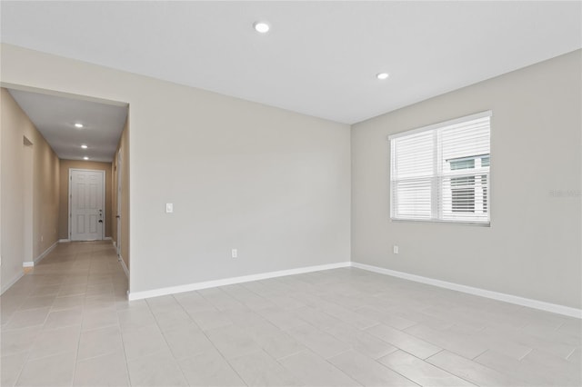 unfurnished room with light tile patterned floors