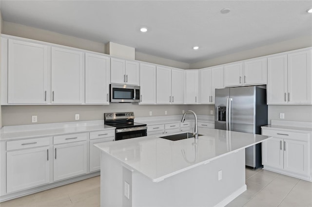 kitchen with a center island with sink, white cabinetry, sink, and appliances with stainless steel finishes