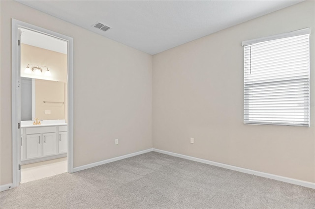 carpeted empty room featuring sink