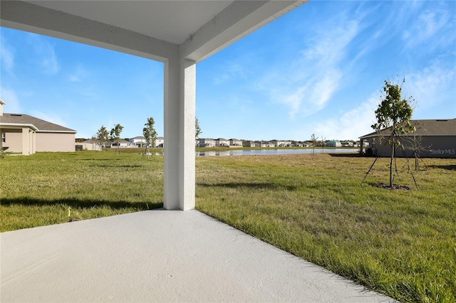 view of yard featuring a water view and a patio