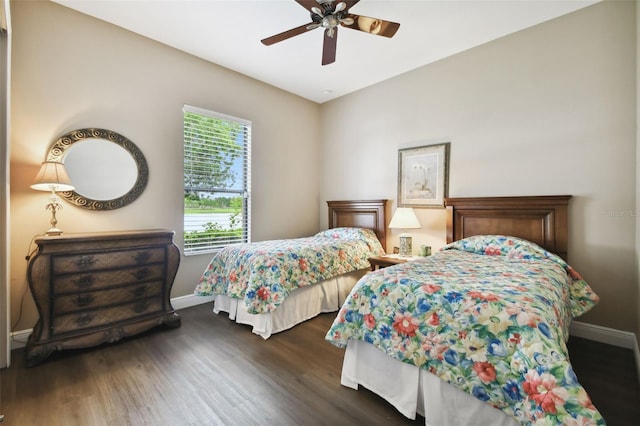 bedroom with dark hardwood / wood-style floors and ceiling fan