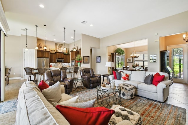 tiled living room with a notable chandelier