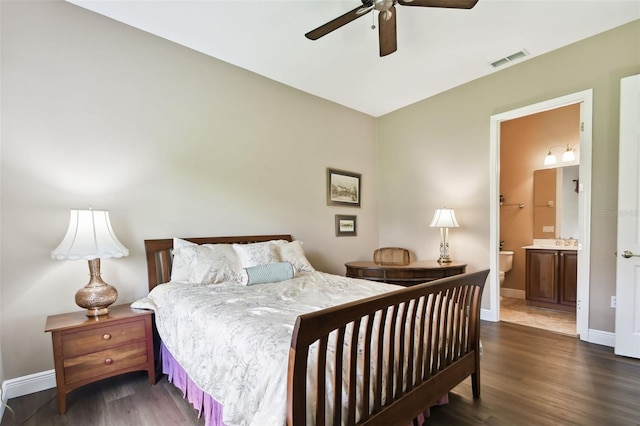 bedroom featuring ceiling fan, dark hardwood / wood-style floors, and ensuite bath