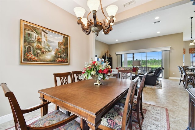 tiled dining space featuring a chandelier