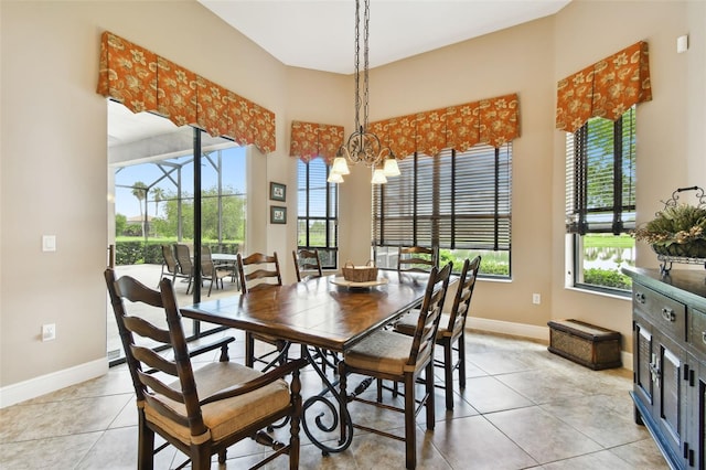 tiled dining area with an inviting chandelier and plenty of natural light